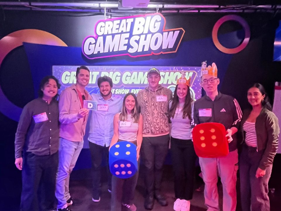 The Banquet team at a game show night, holding giant dice